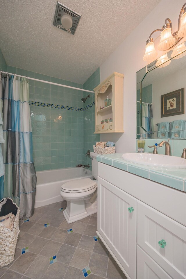 8130 A1A S H12, Saint Augustine, FL 32080 - full bath with shower / bath combo with shower curtain, vanity, tile patterned flooring, and a textured ceiling