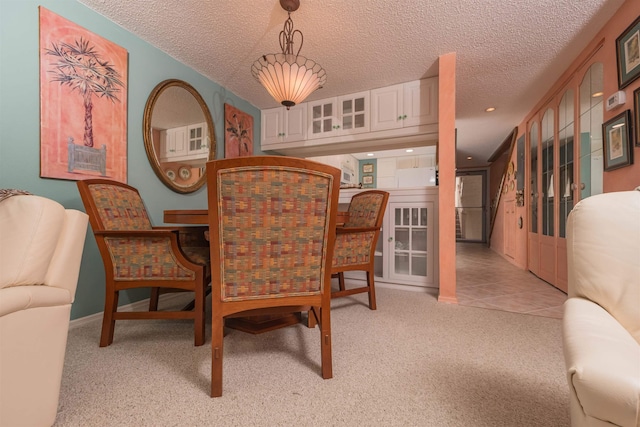 8130 A1A S H12, Saint Augustine, FL 32080 - dining area with light colored carpet and a textured ceiling