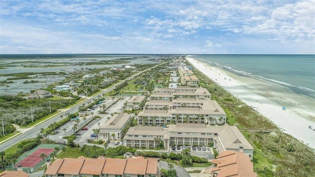 drone / aerial view featuring a beach view and a water view