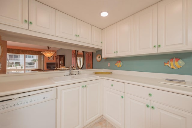 kitchen with dishwasher, white cabinets, light tile patterned floors, and sink