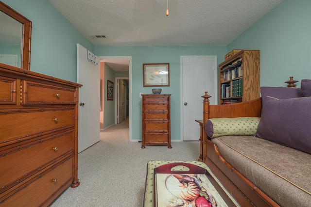 carpeted bedroom with a textured ceiling