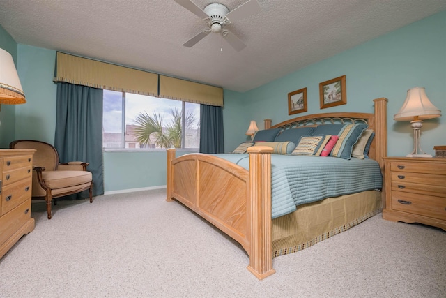 bedroom featuring carpet, ceiling fan, and a textured ceiling