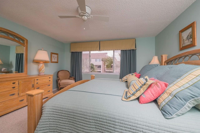 carpeted bedroom with a textured ceiling and ceiling fan