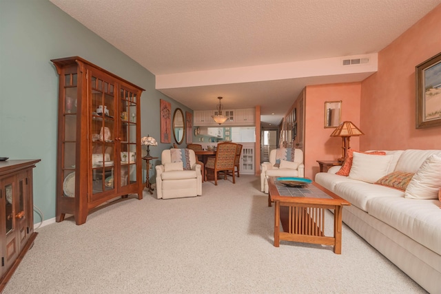 8130 A1A S H12, Saint Augustine, FL 32080 - carpeted living area featuring a textured ceiling