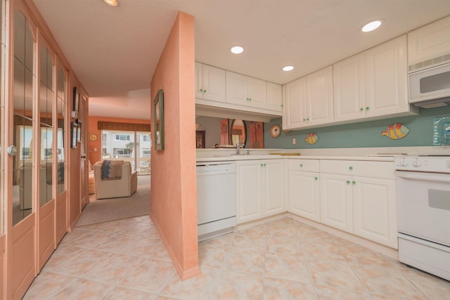 8130 A1A S H12, Saint Augustine, FL 32080 - kitchen with white appliances, light countertops, white cabinetry, light tile patterned flooring, and recessed lighting