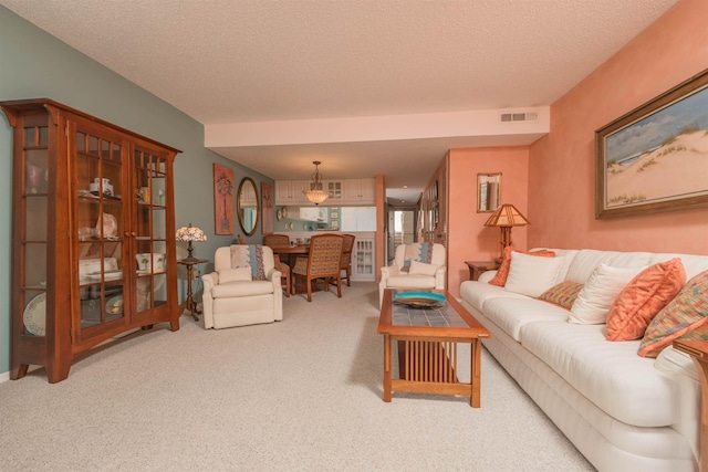 living room featuring carpet flooring and a textured ceiling