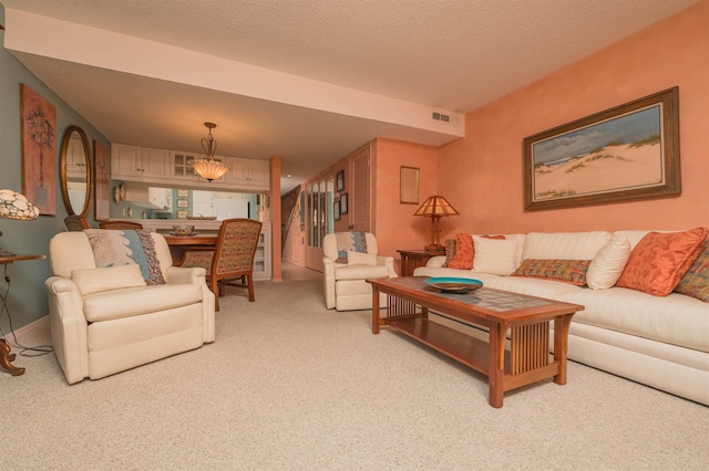 living room with light carpet and a textured ceiling