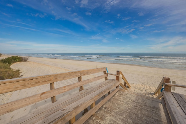 view of community featuring a beach view and a water view