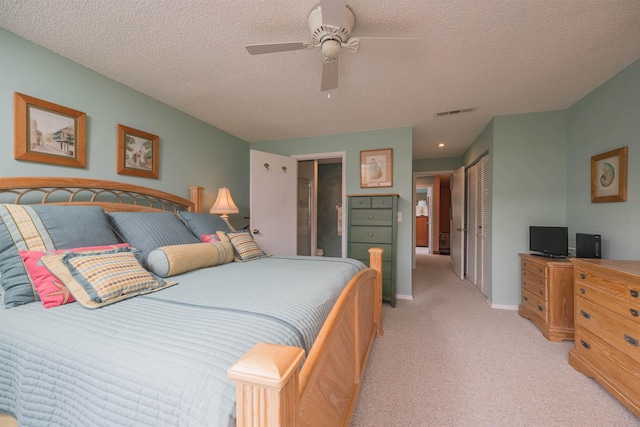 bedroom with light carpet, a textured ceiling, a closet, and ceiling fan