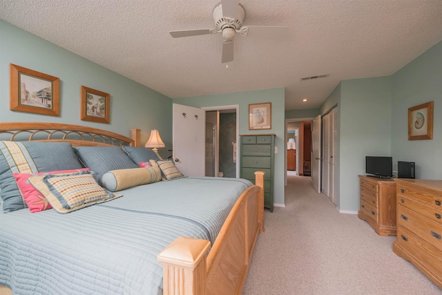 8130 A1A S H12, Saint Augustine, FL 32080 - bedroom with light carpet, a closet, a textured ceiling, an office area, and a ceiling fan