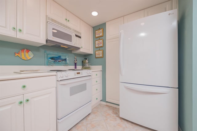 kitchen featuring white cabinets, light tile patterned flooring, and white appliances