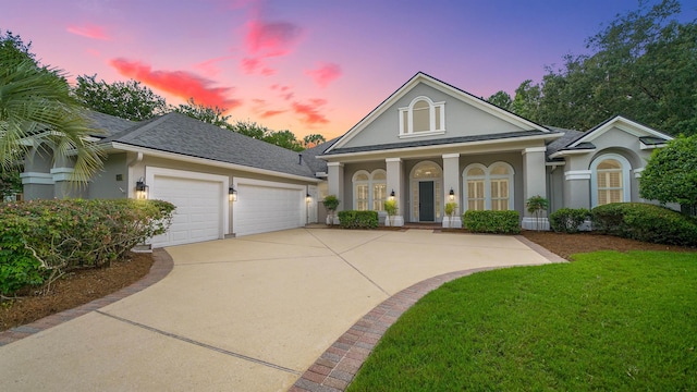 view of front of property featuring a yard and a garage