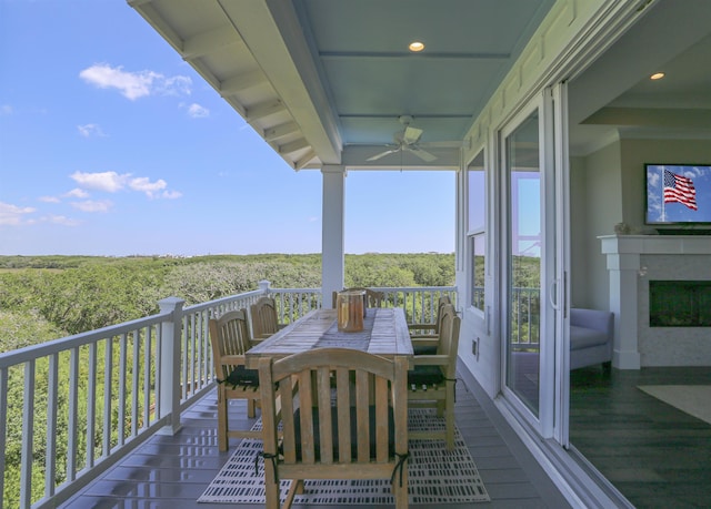 wooden balcony featuring a wooden deck and ceiling fan