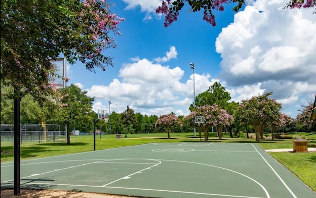 view of sport court featuring a lawn