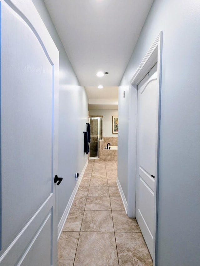 hall featuring light tile patterned floors