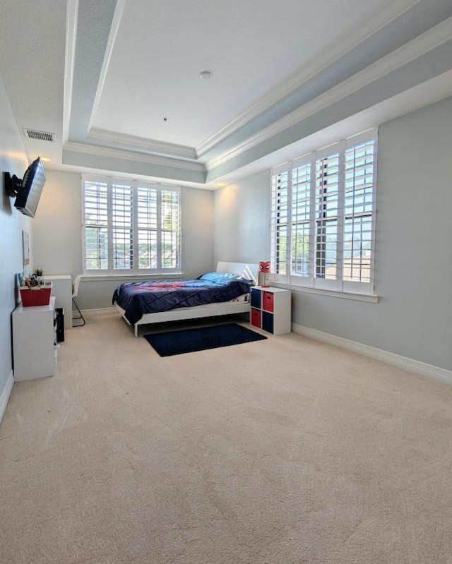 carpeted bedroom featuring a raised ceiling, multiple windows, and crown molding