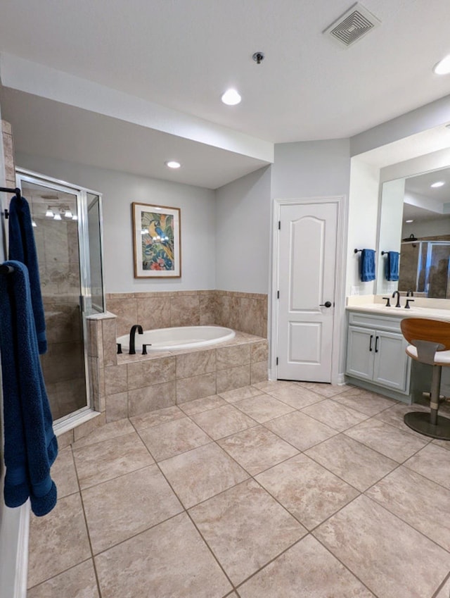 bathroom with tile patterned flooring, vanity, and separate shower and tub