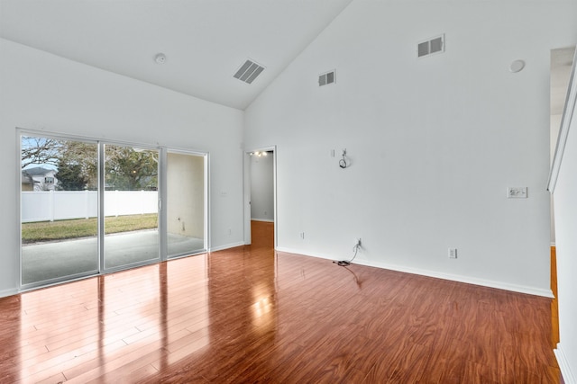 unfurnished room with wood finished floors and visible vents