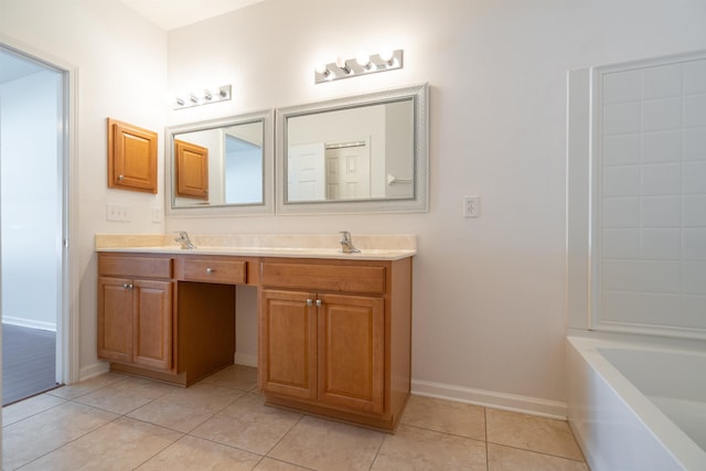 bathroom with tile patterned floors, a bath, double vanity, and a sink