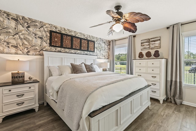 2077 W Lymington Way, Saint Augustine, FL 32084 - bedroom with wallpapered walls, multiple windows, wood finished floors, and baseboards