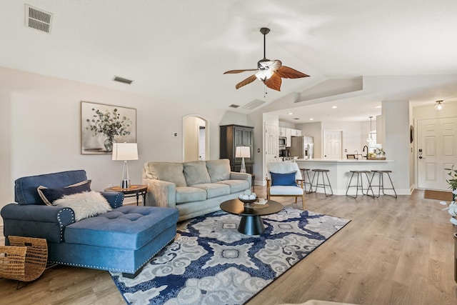 2077 W Lymington Way, Saint Augustine, FL 32084 - living room featuring ceiling fan, lofted ceiling, light wood-type flooring, arched walkways, and baseboards