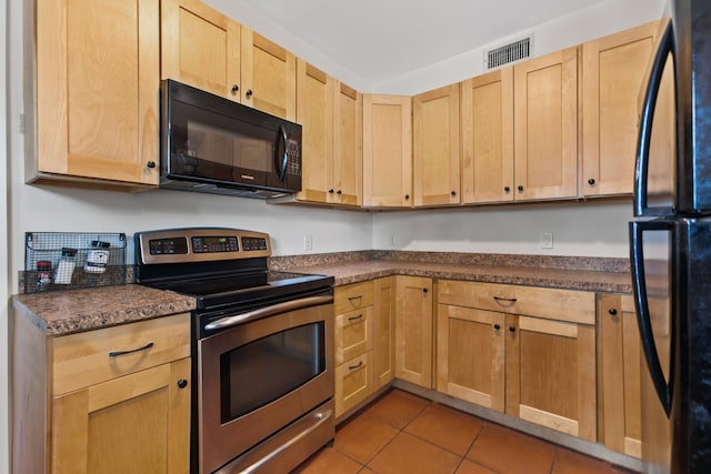 85 N Saint Augustine Blvd Unit 1, Saint Augustine, FL 32080 - kitchen featuring black appliances, light brown cabinets, tile patterned floors, and dark countertops
