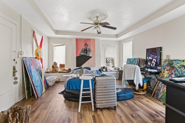 85 N Saint Augustine Blvd Unit 1, Saint Augustine, FL 32080 - bedroom with a raised ceiling, wood finished floors, a ceiling fan, a textured ceiling, and baseboards