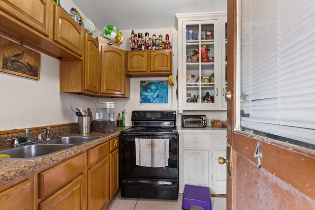 85 N Saint Augustine Blvd Unit 1, Saint Augustine, FL 32080 - kitchen featuring black range with electric cooktop, a sink, brown cabinets, and light tile patterned floors