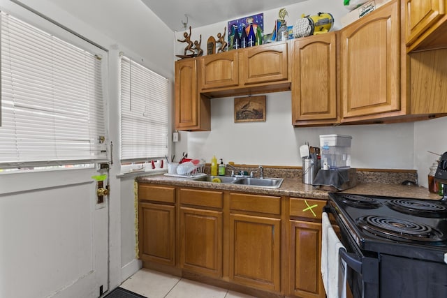 85 N Saint Augustine Blvd Unit 1, Saint Augustine, FL 32080 - kitchen featuring electric range, a sink, brown cabinetry, and light tile patterned floors