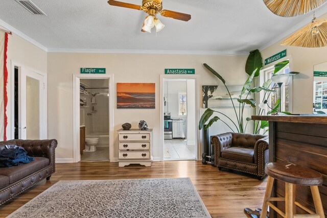 85 N Saint Augustine Blvd Unit 1, Saint Augustine, FL 32080 - sitting room featuring wood finished floors, ornamental molding, ceiling fan, and baseboards
