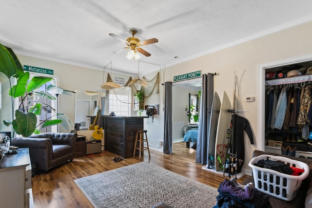 85 N Saint Augustine Blvd Unit 1, Saint Augustine, FL 32080 - living room featuring ceiling fan, crown molding, wood finished floors, and a textured ceiling