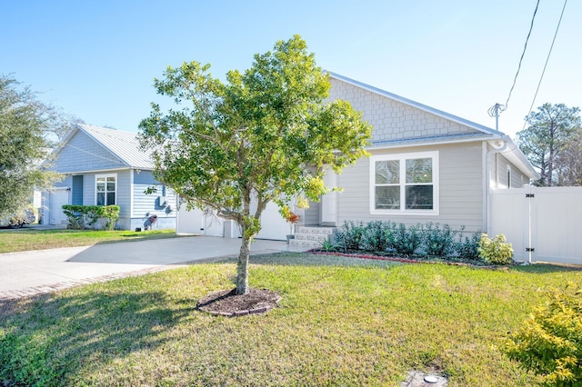 view of front of house featuring a garage and a front yard