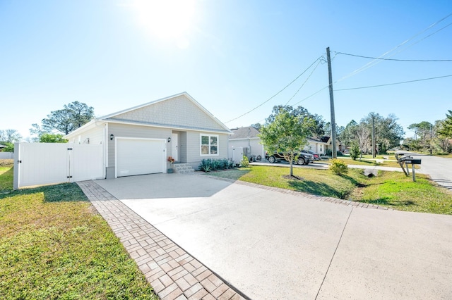 view of front of house with a garage and a front lawn