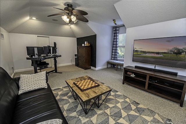 living room featuring light carpet, baseboards, a ceiling fan, lofted ceiling, and a textured ceiling