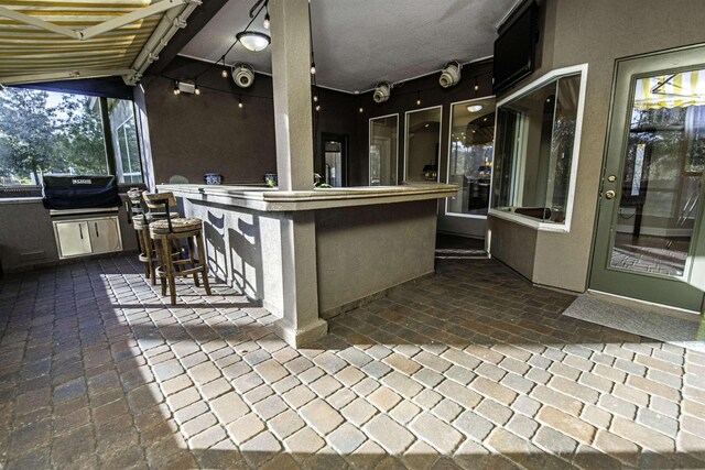 view of patio with outdoor dry bar, grilling area, and area for grilling