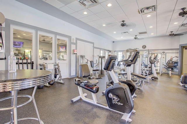 workout area featuring a paneled ceiling, a ceiling fan, visible vents, and recessed lighting