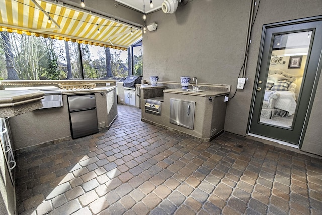 view of patio / terrace featuring a sink and area for grilling