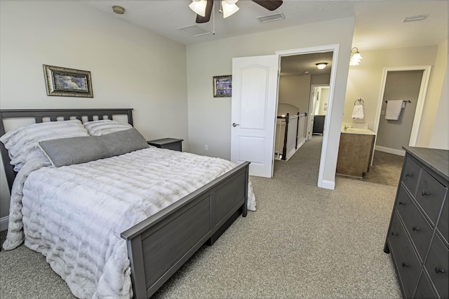 bedroom with baseboards, ceiling fan, visible vents, and light colored carpet