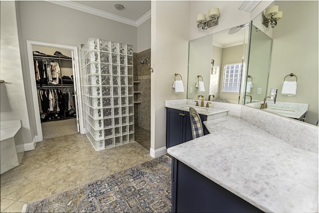 bathroom with crown molding, vanity, baseboards, and a walk in shower