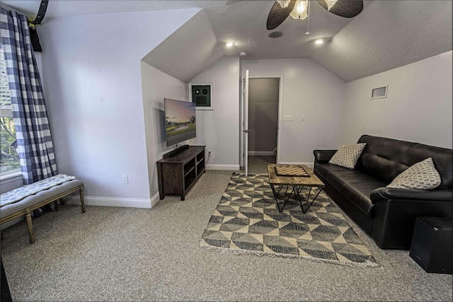 living area featuring baseboards, visible vents, lofted ceiling, a textured ceiling, and carpet floors