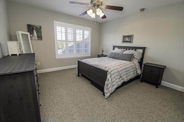 carpeted bedroom featuring ceiling fan and baseboards