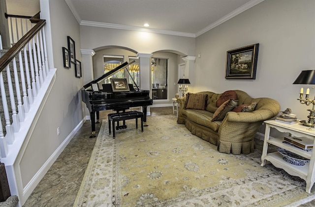 living area with decorative columns, baseboards, arched walkways, stairway, and crown molding