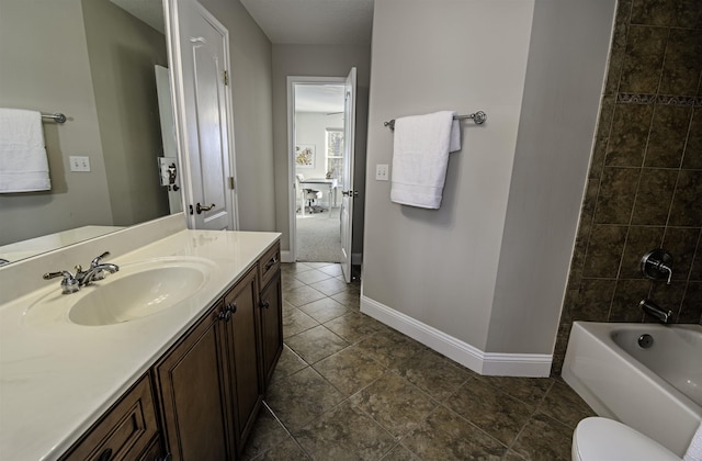 bathroom with shower / bath combination, toilet, vanity, and baseboards