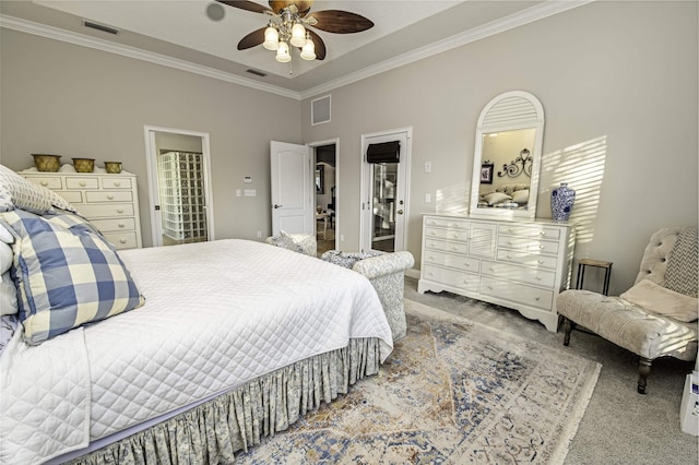 bedroom with ornamental molding, carpet, visible vents, and a ceiling fan