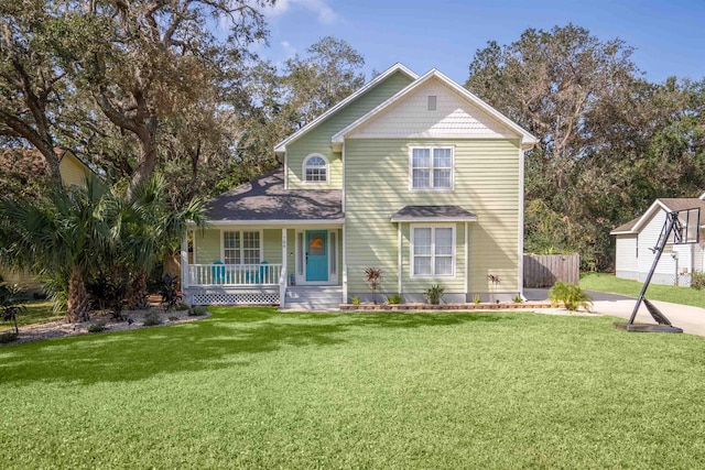 view of front of house with covered porch and a front yard