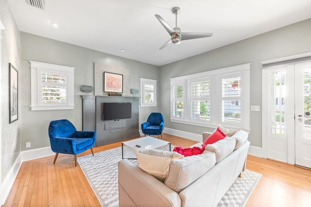 living room with ceiling fan and light hardwood / wood-style floors