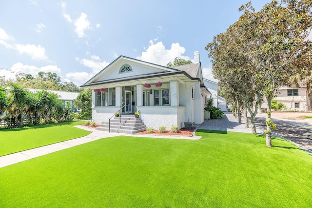 view of front of home with a front lawn and covered porch