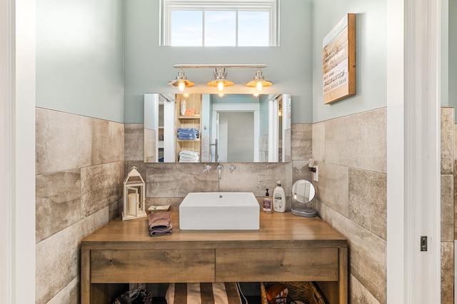 bathroom with vanity and tile walls