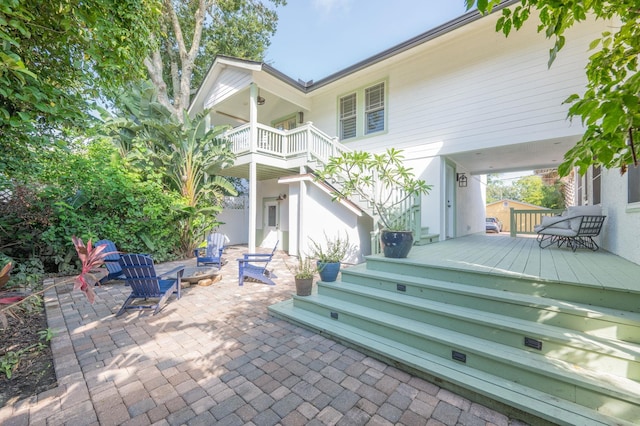 back of house with a patio, a balcony, and a wooden deck