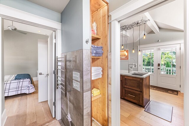 bathroom featuring vanity, hardwood / wood-style floors, lofted ceiling with beams, and ceiling fan